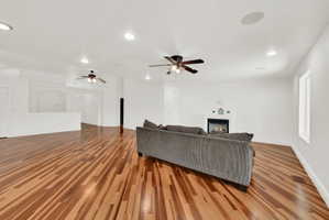 Open concept living area featuring wood-finish flooring, recessed lighting, and ceiling fans