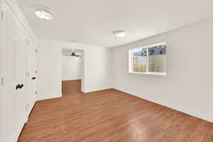 Bright room featuring wood-finish flooring and neutral wall tones