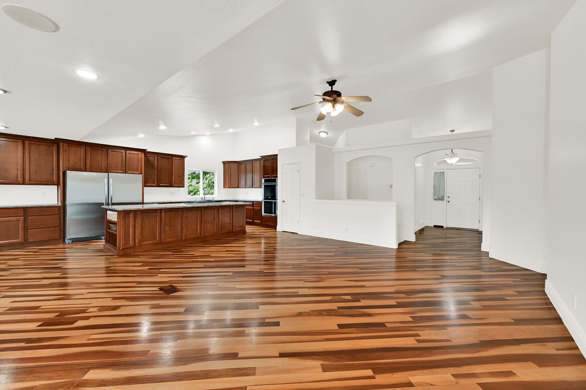 Spacious kitchen and living area featuring wood-finish flooring