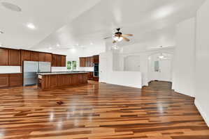 Spacious kitchen and living area featuring wood-finish flooring