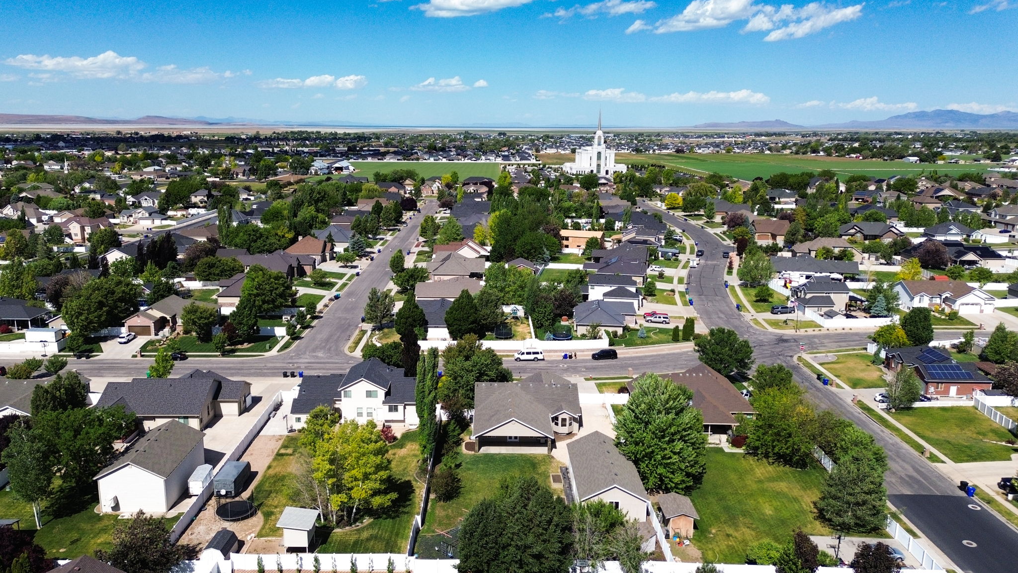 Residential neighborhood featuring a variety of single-family homes, mature trees, and paved streets