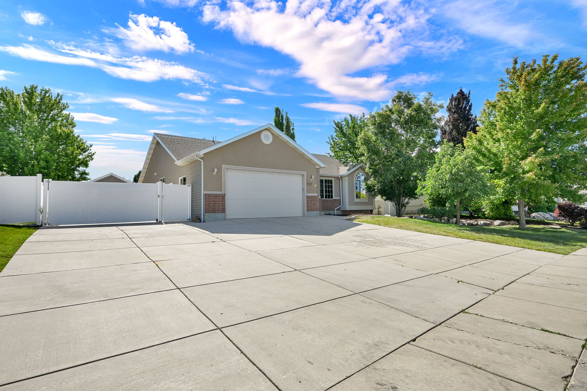 Expansive concrete driveway and two-car garage