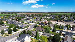 Residential neighborhood with mature trees, established streets, and distant mountain views