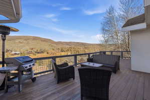 Expansive outdoor deck featuring wood-finish flooring and a metal railing system
