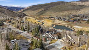 Aerial perspective showcasing a residential community nestled within a mountainous valley