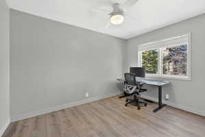 Room featuring neutral gray walls, wood-finish flooring, and white baseboards