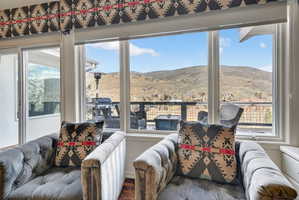 Window wall featuring expansive mountain scenery and a private outdoor deck