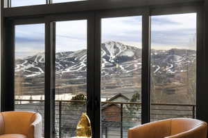 Expansive sliding glass doors framing snow-capped mountains