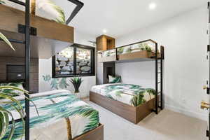 Room featuring two built-in bunk bed structures with wood-finish frames and black metal accents