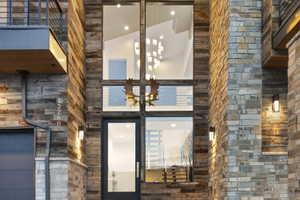 Modern architectural facade featuring stacked stone and wood-finish siding