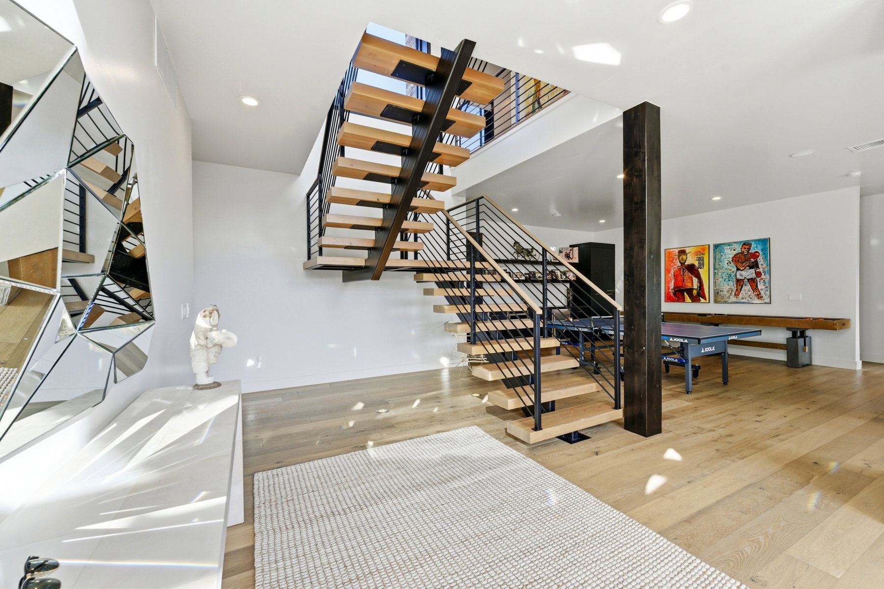 Open-tread staircase with metal railings and wood-finish steps