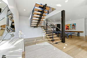 Open-tread staircase with metal railings and wood-finish steps