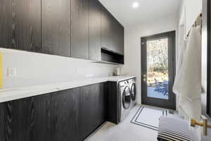 Utility room with dark wood-finish cabinetry, white countertop, and under-cabinet lighting