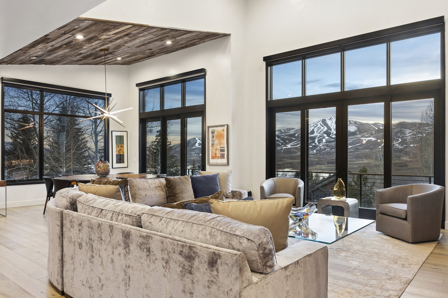 Expansive living area with high ceilings and wood-finish flooring