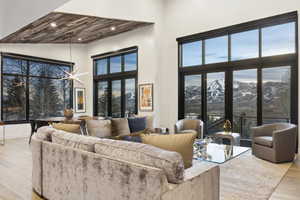 Expansive living area with high ceilings and wood-finish flooring