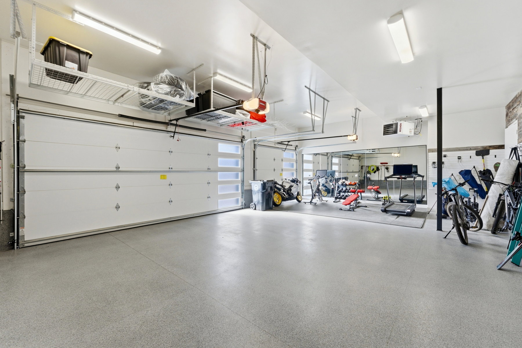 Epoxy-coated concrete flooring extends throughout this expansive garage space