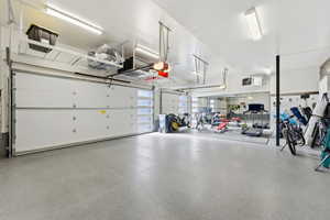 Epoxy-coated concrete flooring extends throughout this expansive garage space