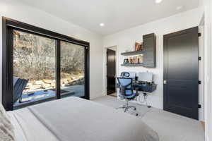 Sliding glass doors opening to a private patio with a built-in spa
