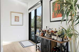 Light wood-finish flooring complements white walls