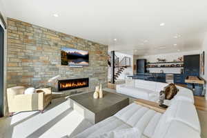 Expansive living area featuring a full-height stone fireplace surround with an integrated linear fireplace
