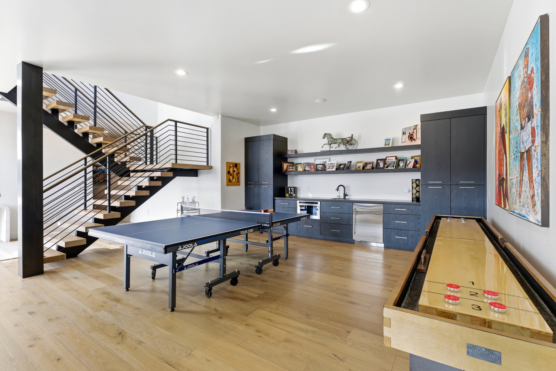 Open-concept recreation area featuring light wood-finish flooring