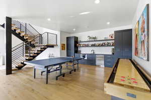 Open-concept recreation area featuring light wood-finish flooring