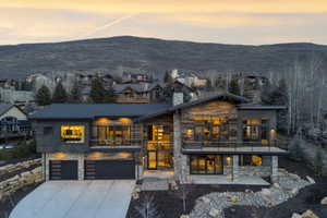 Contemporary mountain residence featuring a stone and wood facade