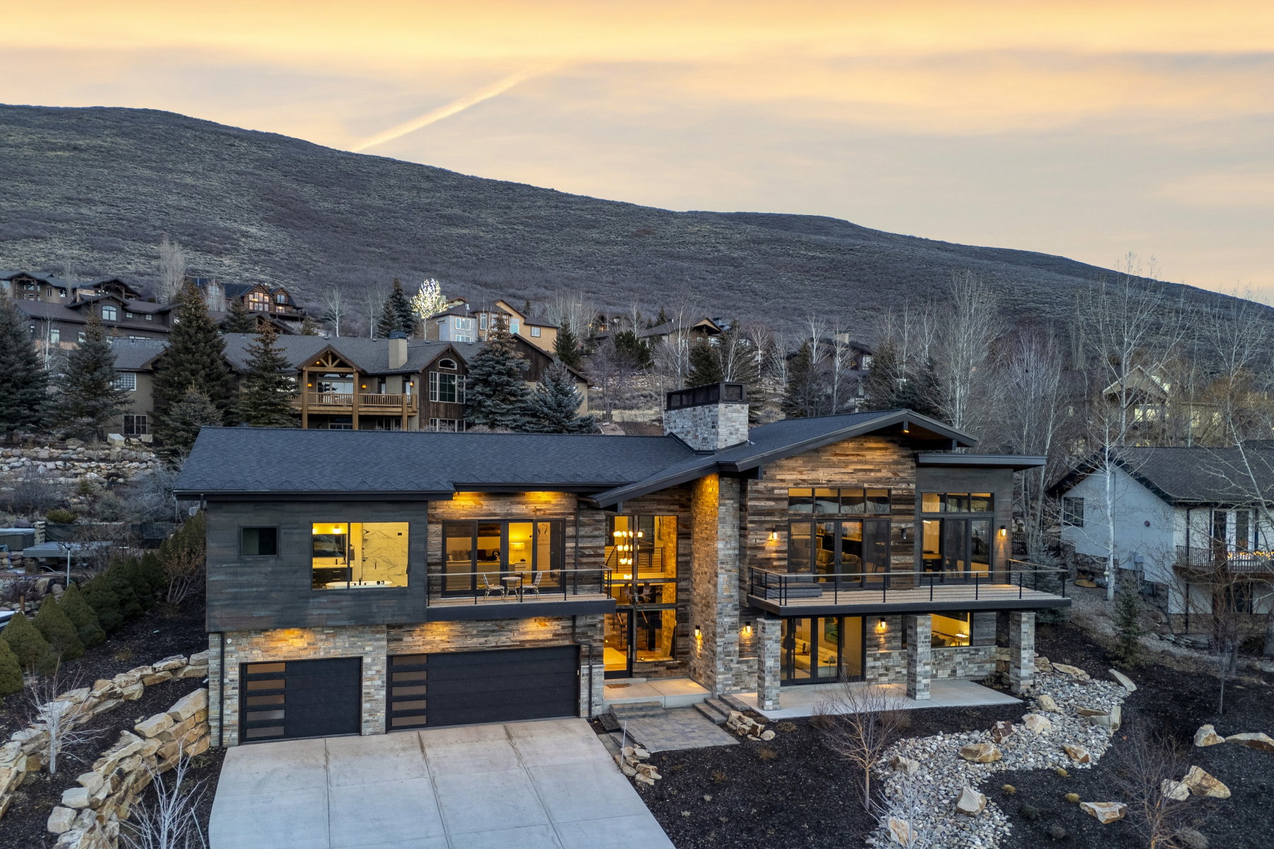 Contemporary mountain-style residence featuring stone and wood-finish siding
