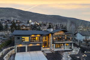 Contemporary mountain-style residence featuring stone and wood-finish siding