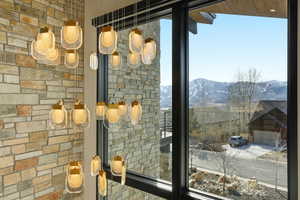 Multi-tiered chandelier with geometric glass pendants and brass accents