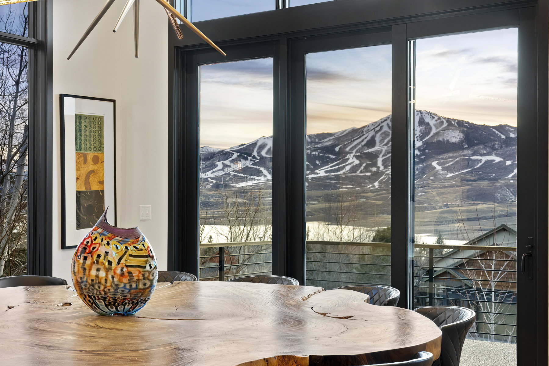 Expansive windows framing mountain and distant water scenery