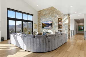 Vaulted ceilings with a stone accent wall and integrated shelving
