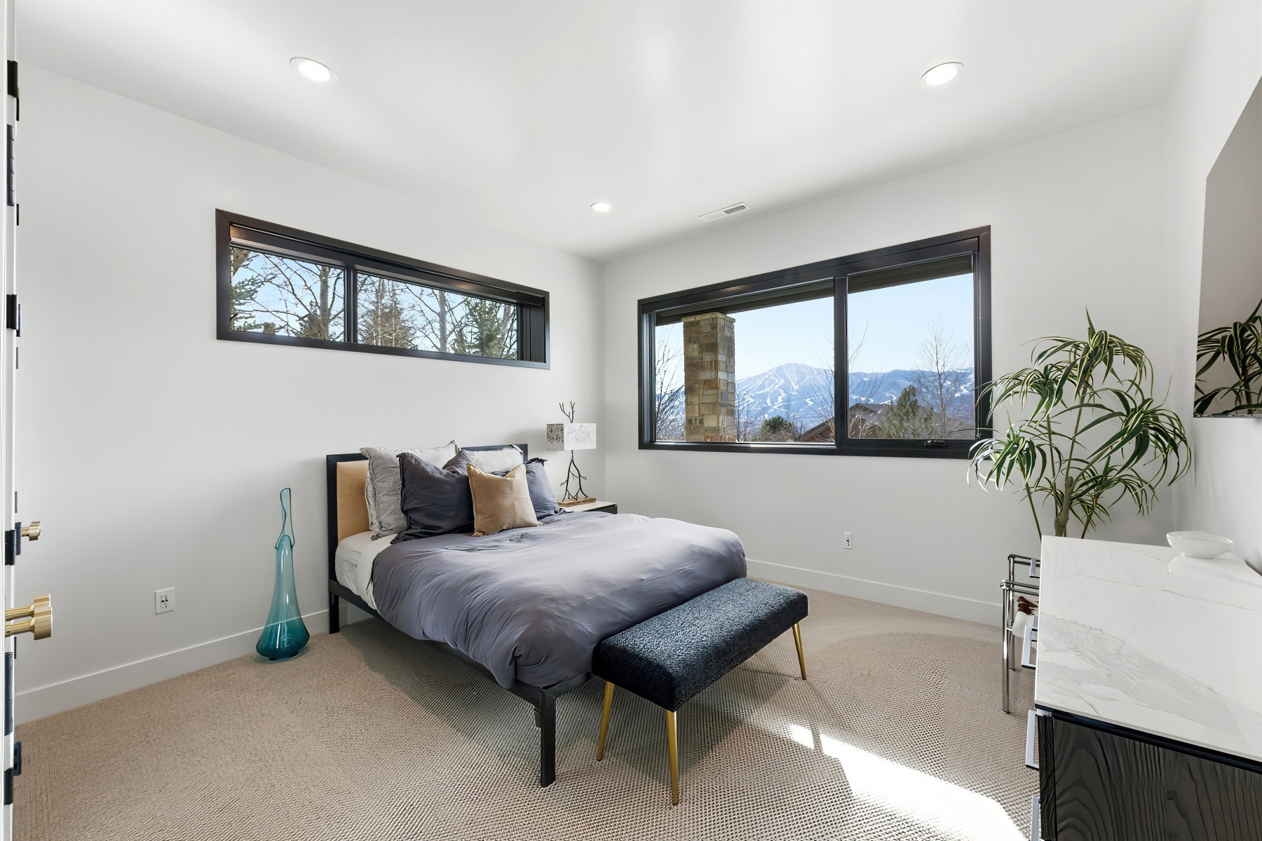 Bright room featuring recessed lighting, a large window with mountain scenery, and an additional transom window