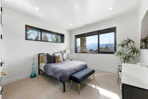 Bright room featuring recessed lighting, a large window with mountain scenery, and an additional transom window