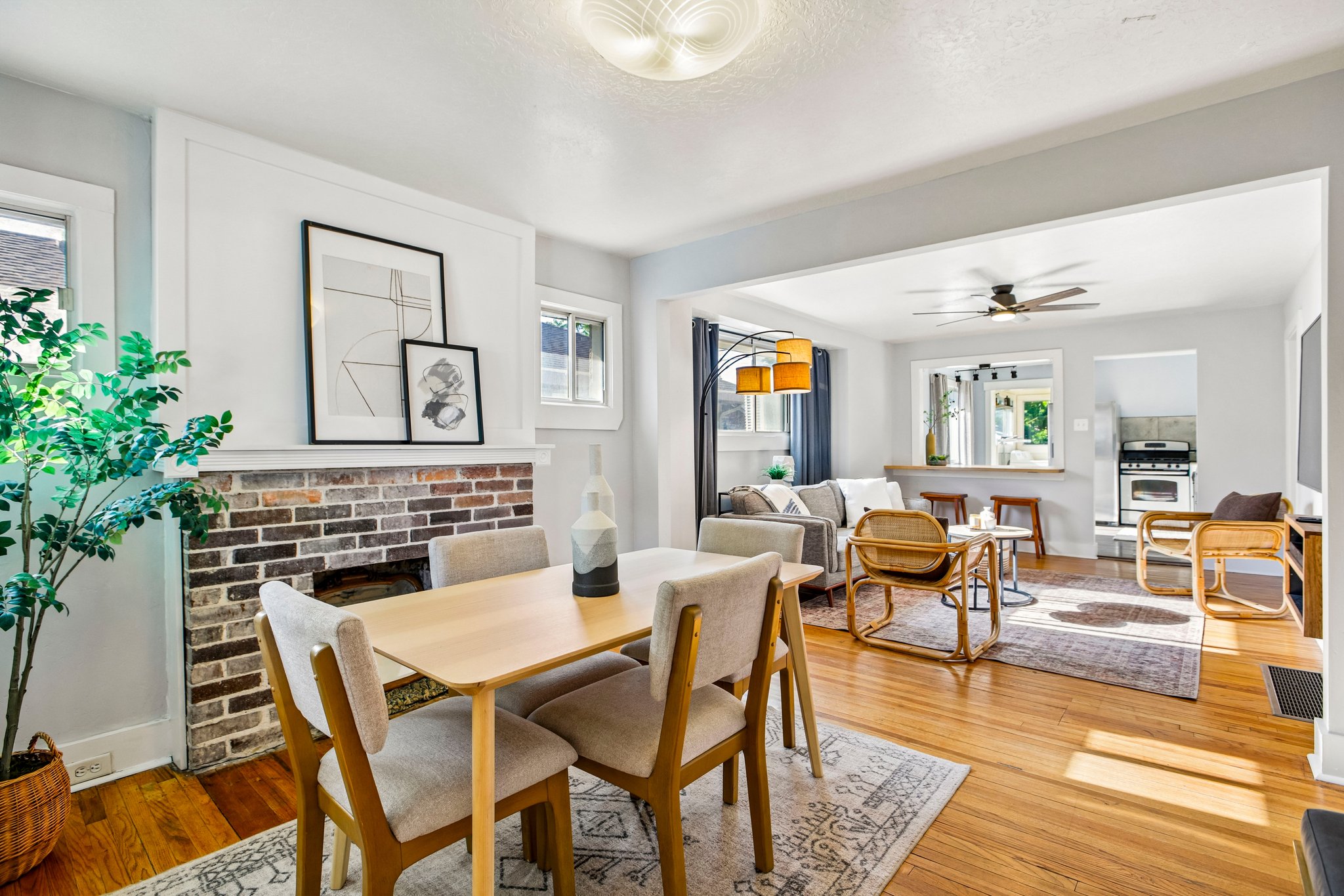 Dining area with a brick fireplace and wood-finish flooring