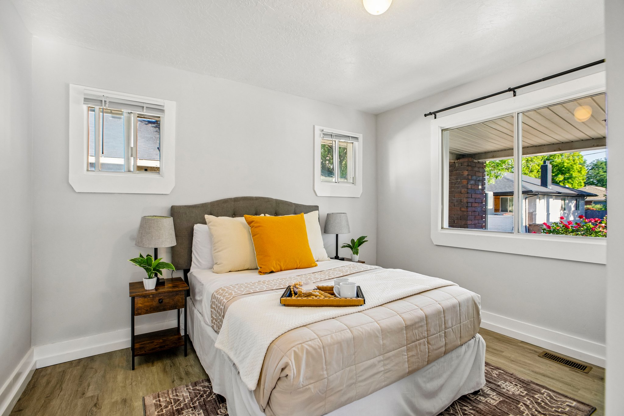 Bright room featuring wood-finish flooring, light grey painted walls, and white trim