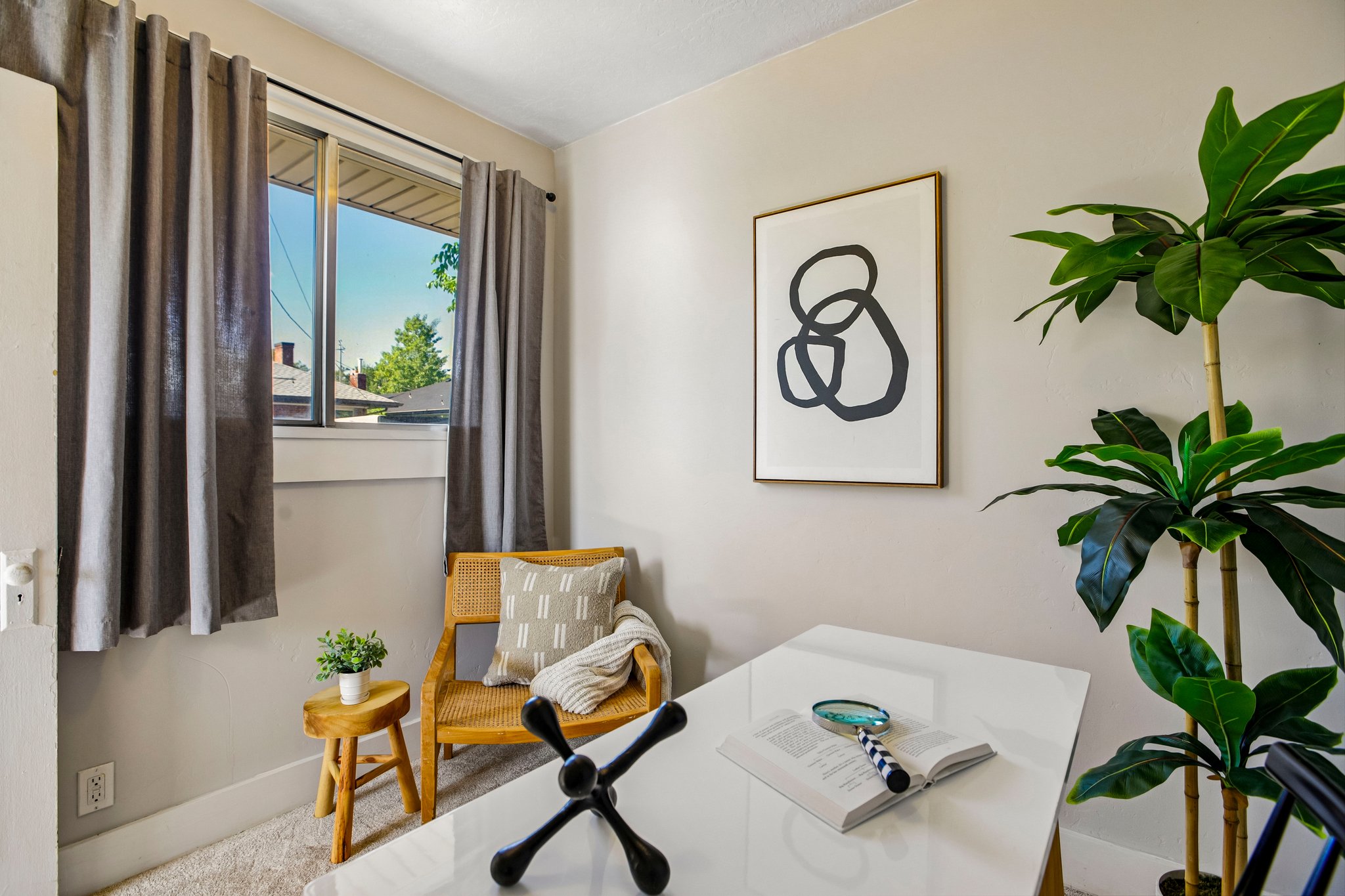 Bright room featuring a window with natural light, light-colored walls, and carpet flooring