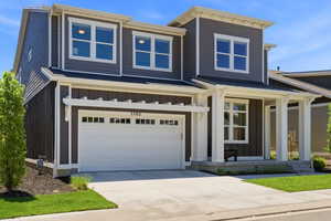 Contemporary two-story residence featuring a dark gray and black exterior with white trim