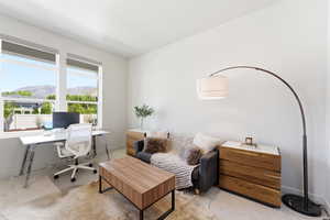 Bright room with large windows, light neutral wall paint, and soft carpet flooring