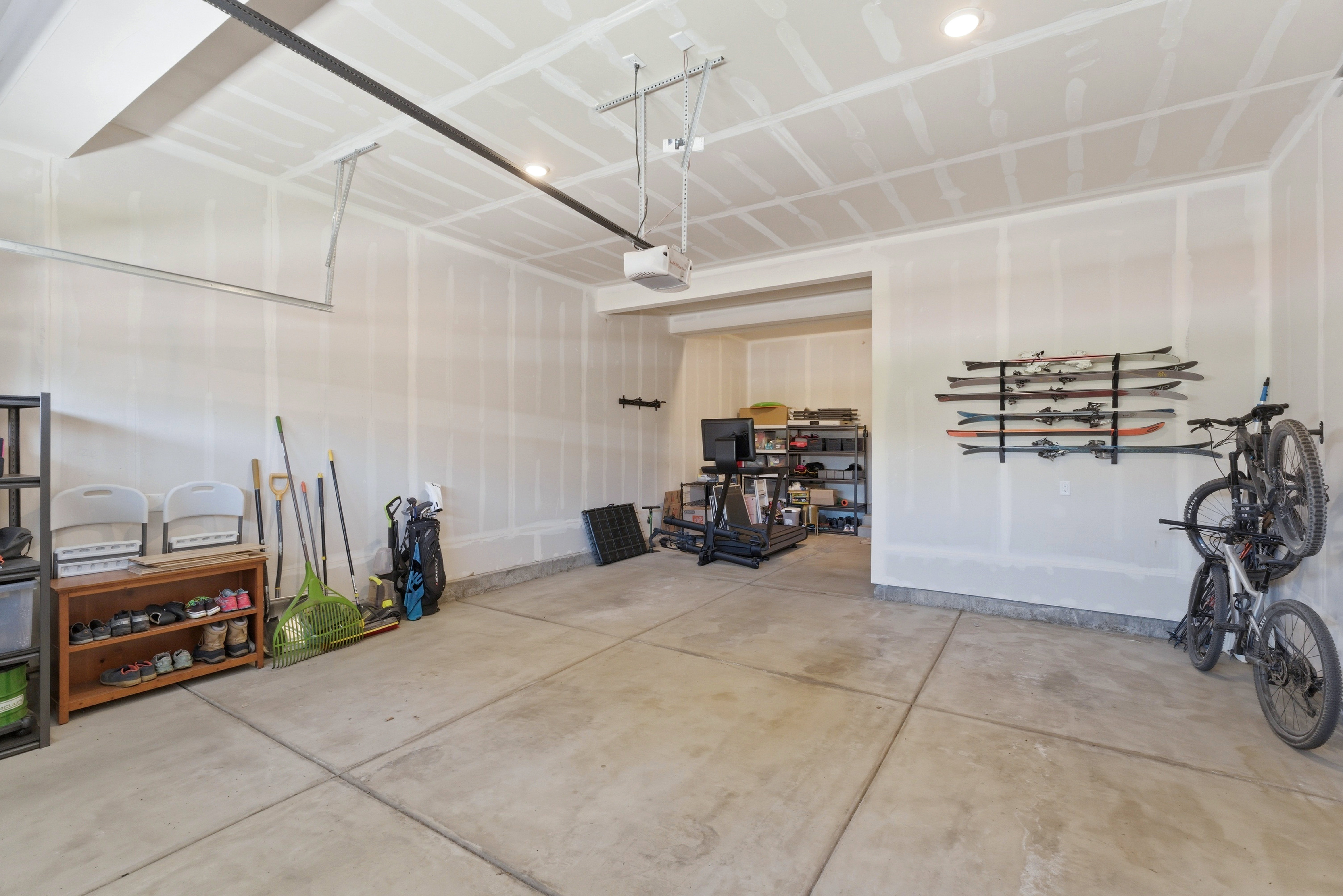 Spacious garage featuring a concrete floor, finished walls, and an overhead lighting fixture