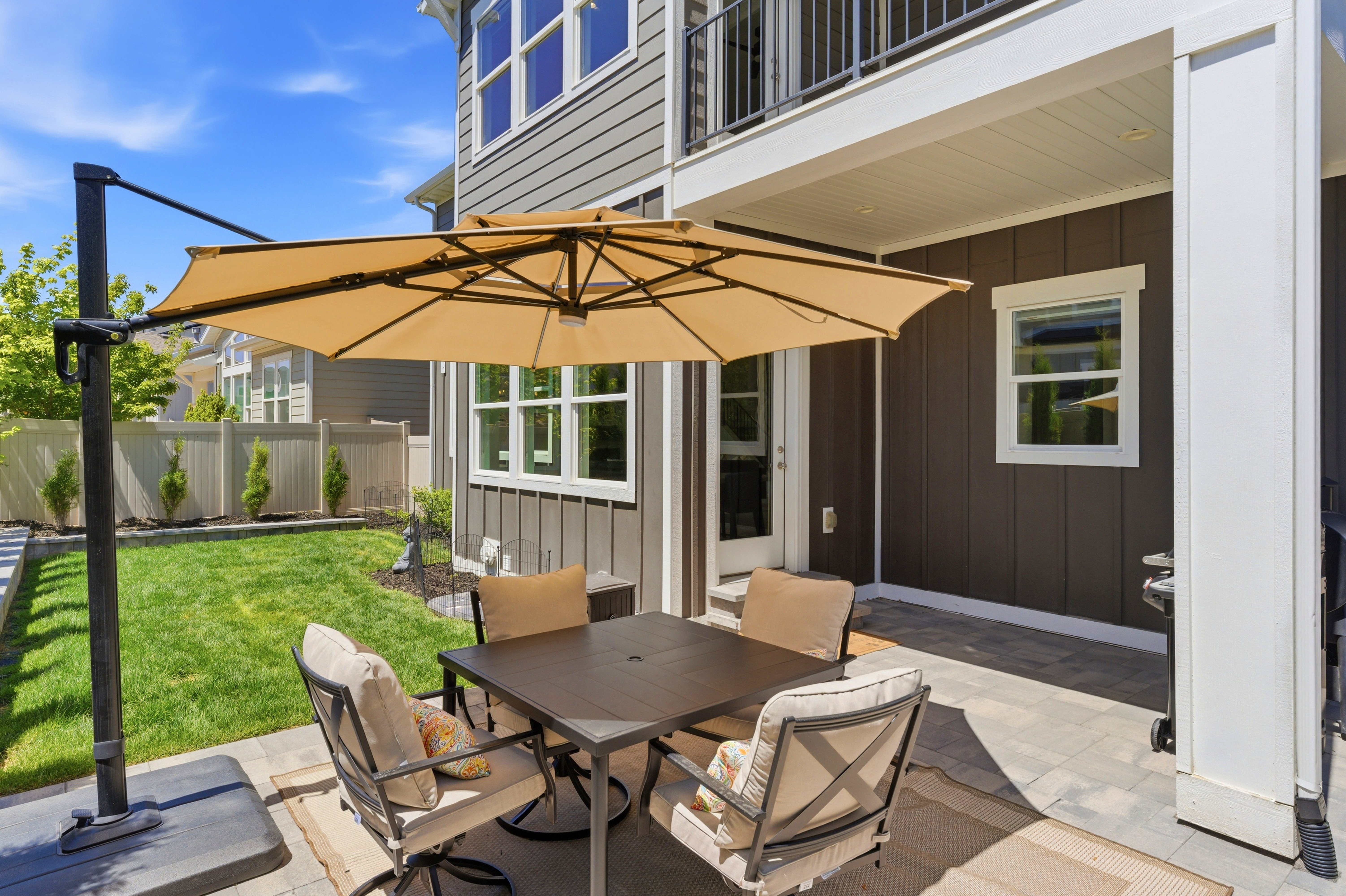 Backyard patio featuring pavers and a manicured lawn
