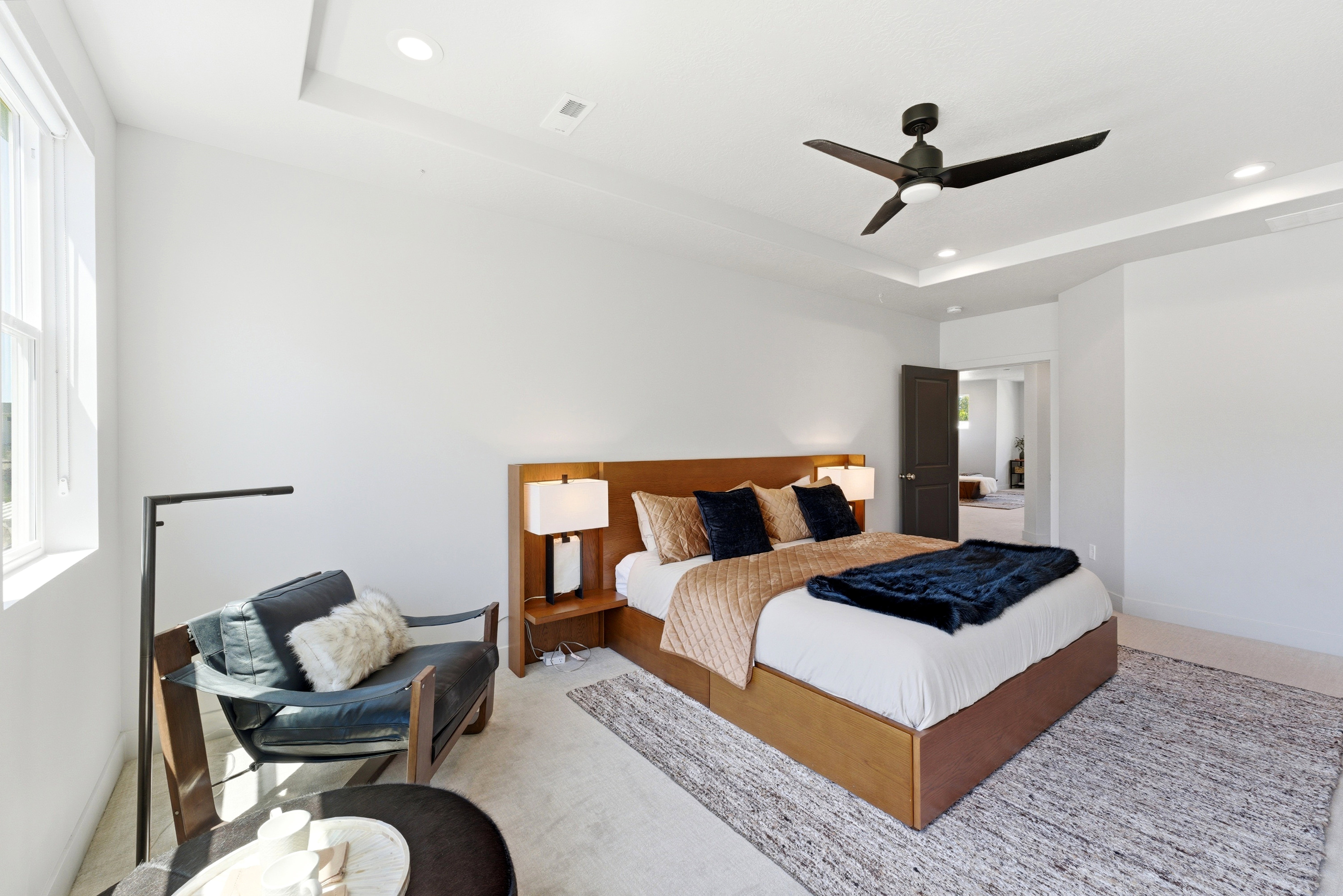 Spacious room with tray ceiling and recessed lighting