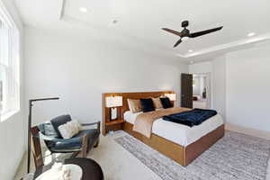 Spacious room with tray ceiling and recessed lighting