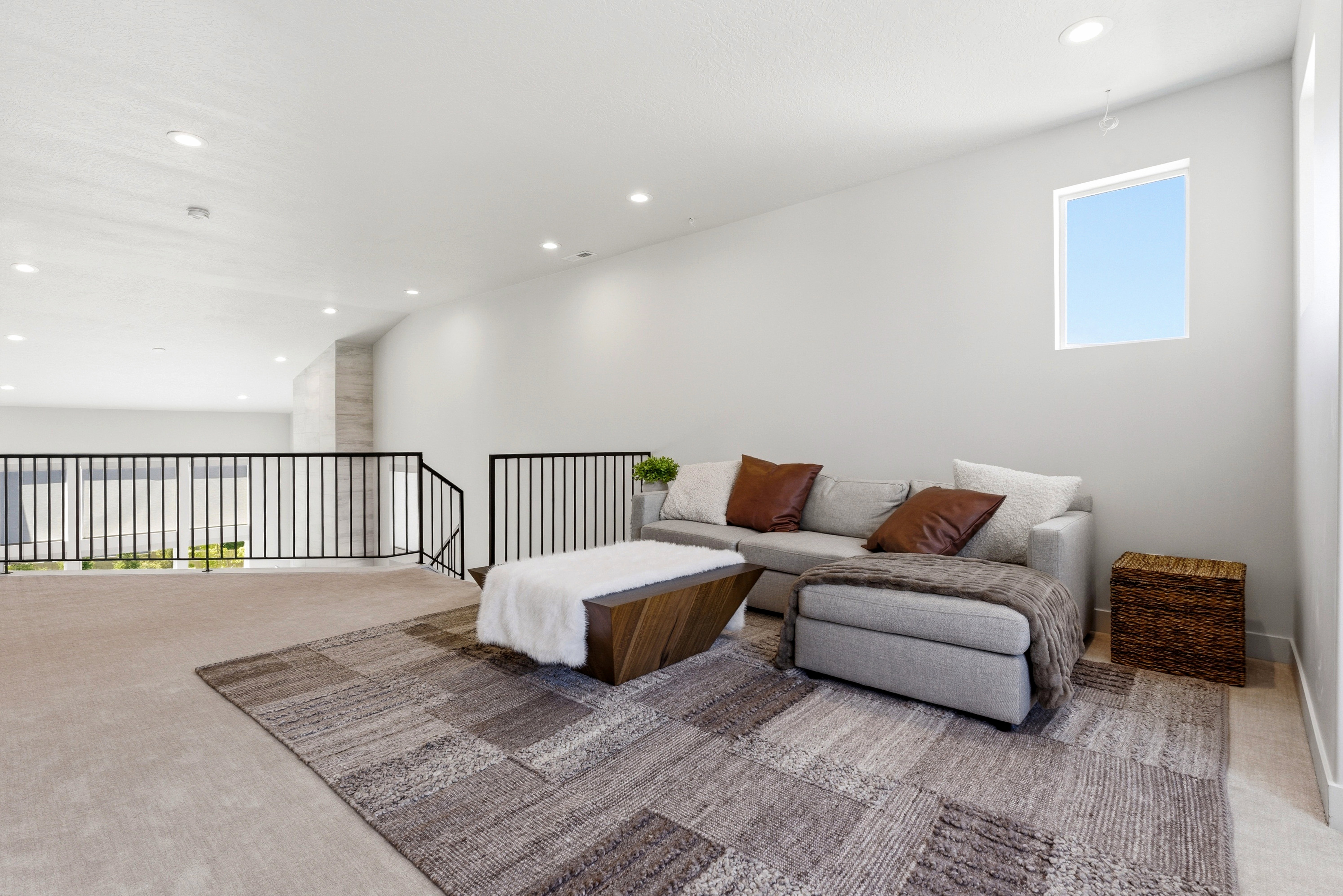 Carpeted loft area featuring a window, recessed lighting, and black metal railings