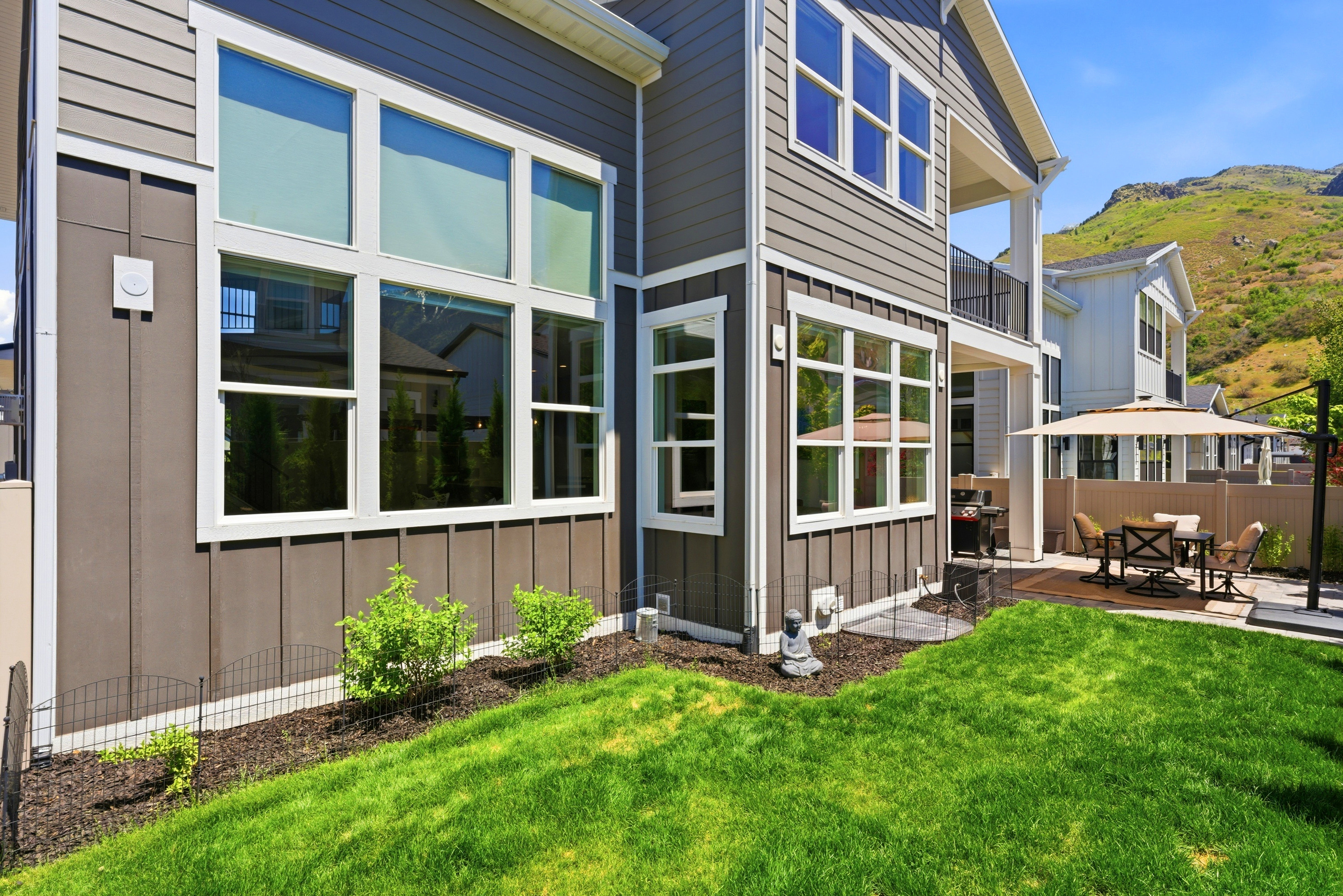 Modern vertical and horizontal siding in a neutral gray tone with white trim