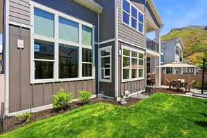 Modern vertical and horizontal siding in a neutral gray tone with white trim