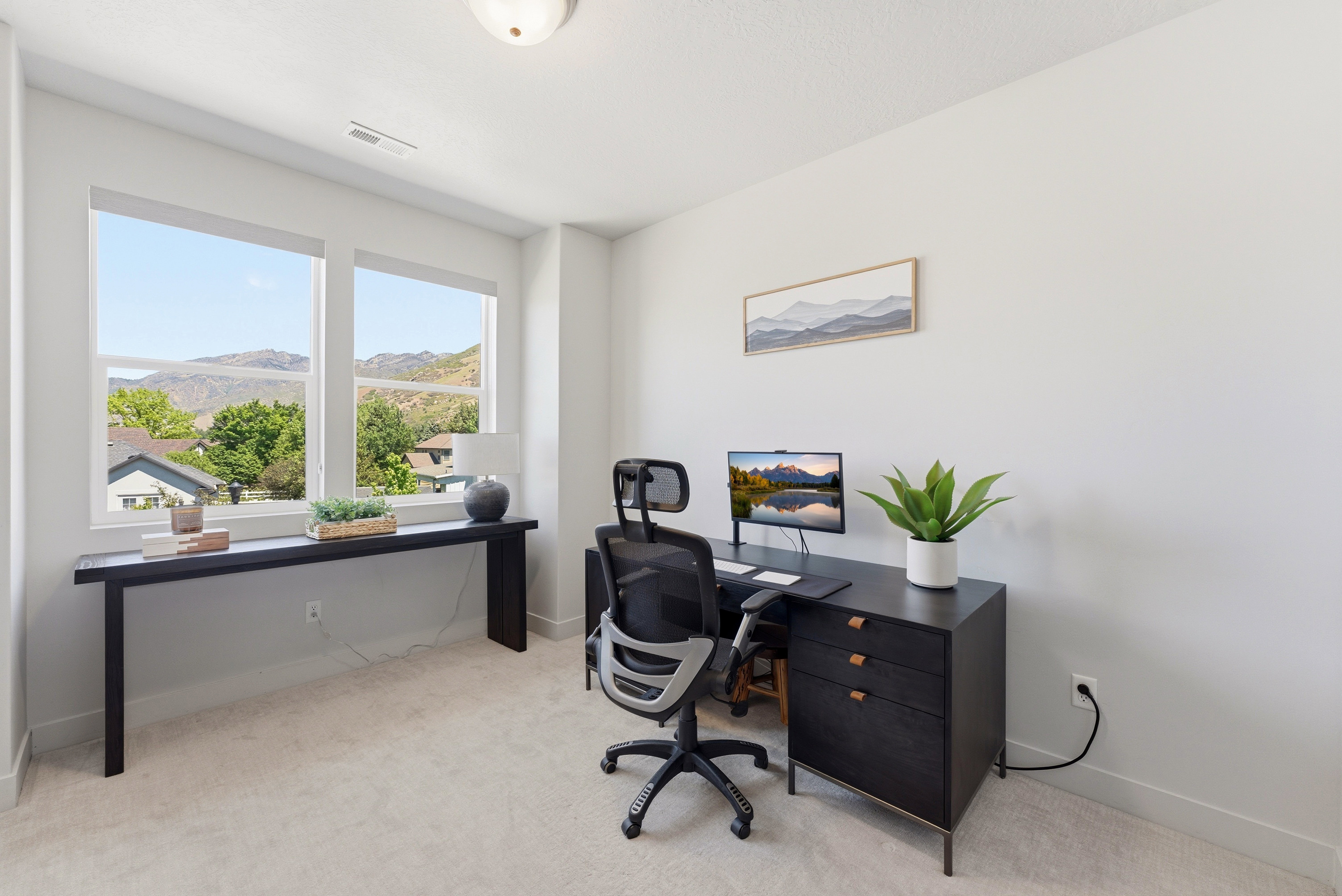 Bright room featuring dual windows with mountain scenery