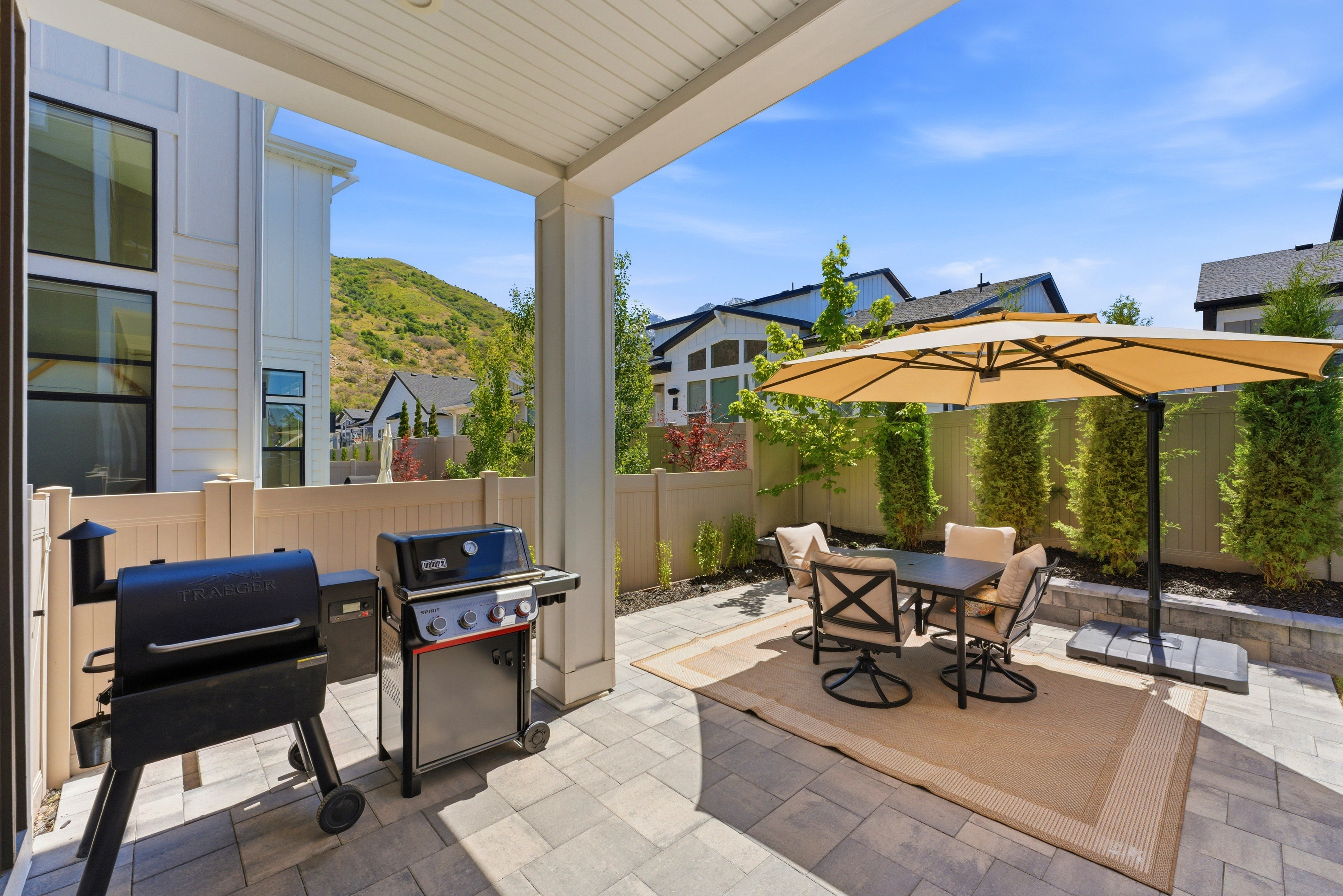 Covered patio featuring paver flooring
