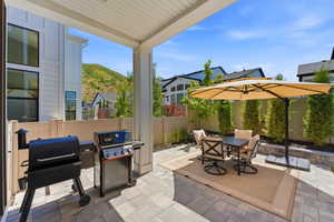 Covered patio featuring paver flooring