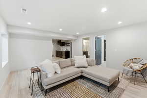 Open-concept living space featuring LVP-finish flooring, recessed lighting, and a neutral color palette
